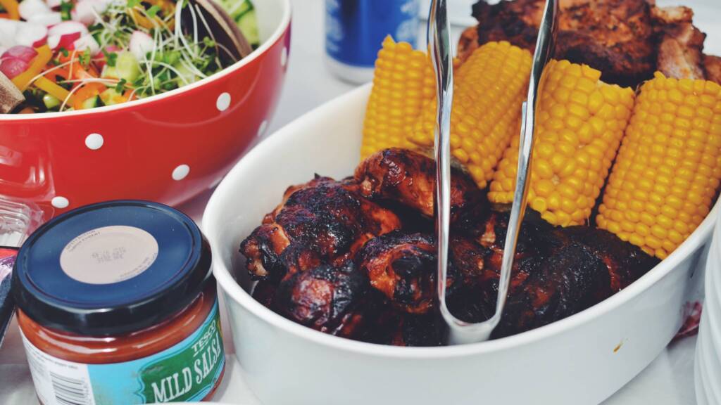 bbq cookout with salad, ribs and corn on the cob